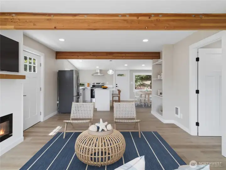 Living room is open to the kitchen and dining area for relaxed entertaining.  Door on the right leads to a bedroom.
