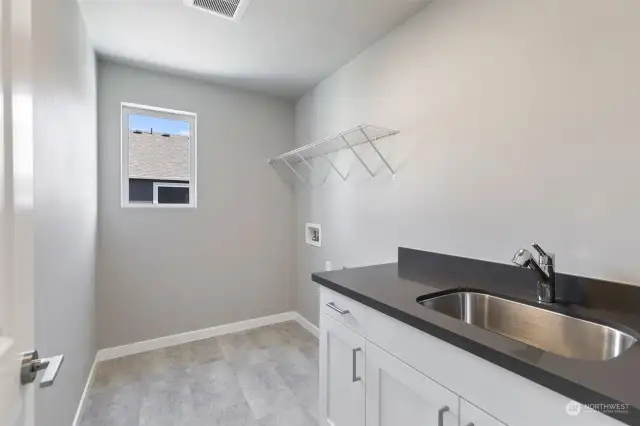Upstairs laundry. Photos are of another home in the community and are for illustration purposes only to reflect floorplan and typical finishes. May depict seller enhancements. Colors and options may vary.