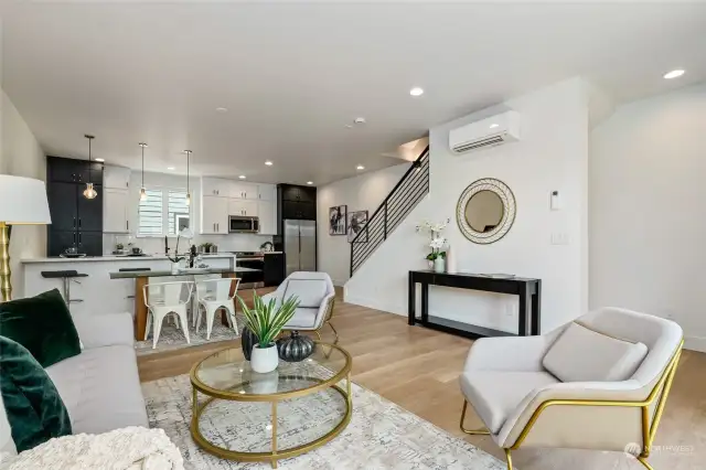 Spacious family room with 9ft ceilings and large windows, perfect for gathering with loved ones and enjoying natural light. Open layout seamlessly connects to the kitchen, creating an inviting and versatile living space.