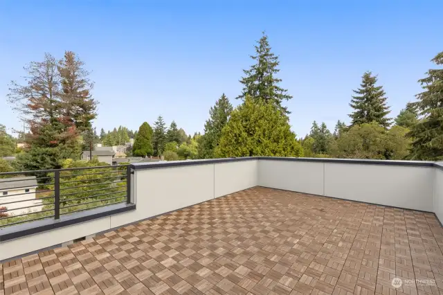 This photo is virtually staged.   Breathe in the fresh air and enjoy sweeping treetop views from your private roof deck. Ideal for hosting or quiet moments of serenity, this space is a showstopper. (virtually staged)