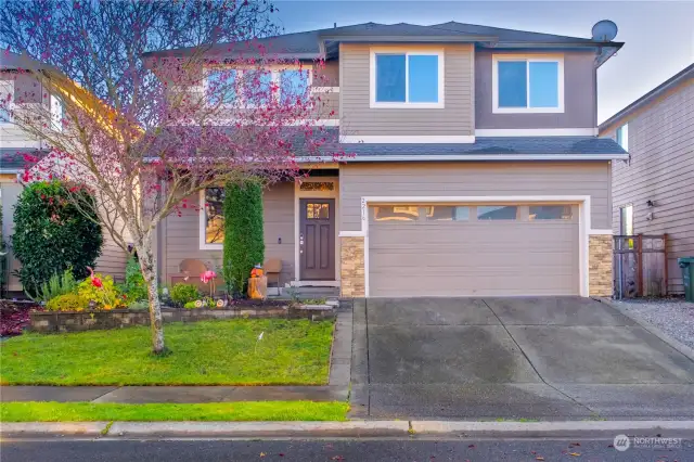 A stylish home with a spacious front yard and a 4-car garage