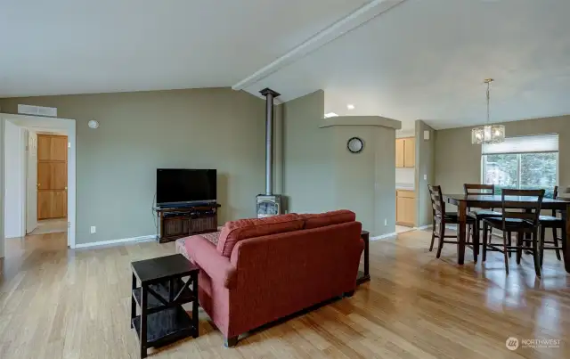 Living room is bright, open and features warm wood floors