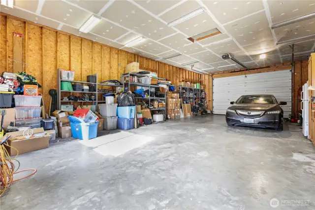 Spacious 1,056 sq. ft. 4+ car shop garage, offering an abundance of floor space, impressive ceiling height, and endless possibilities.