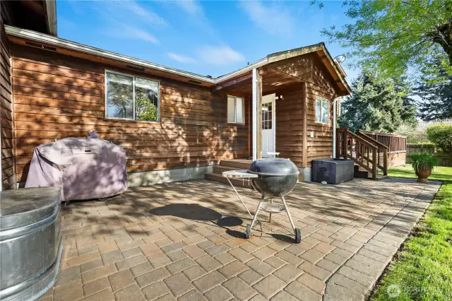 Partially shaded paver patio, perfect for grilling, with direct access to the shop/garage.