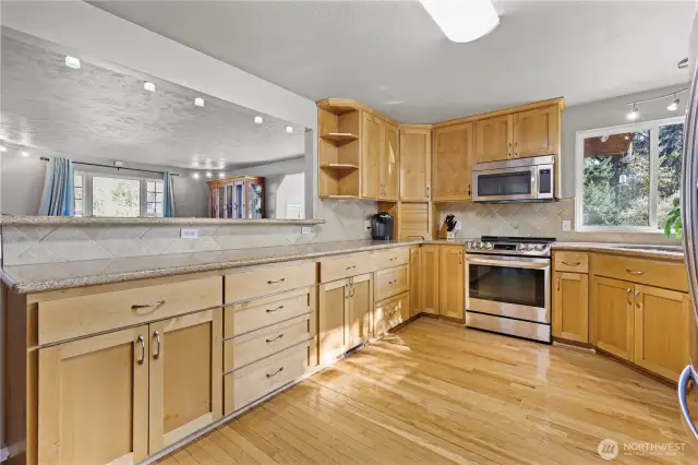 Expansive granite countertops offer generous space for baking, meal preparation, and effortless entertaining