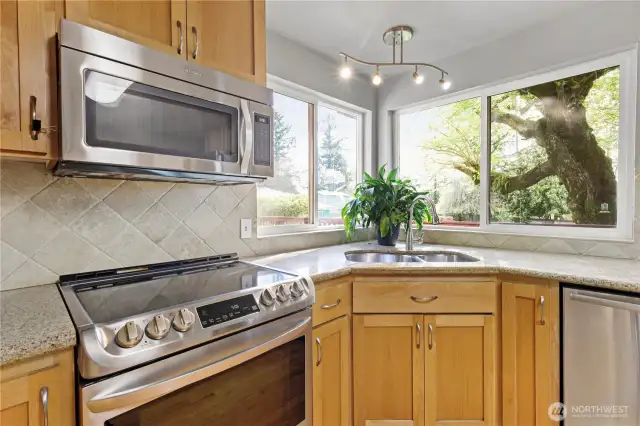 Sunny corner window offers a lovely view of the backyard, bringing the outdoors in.