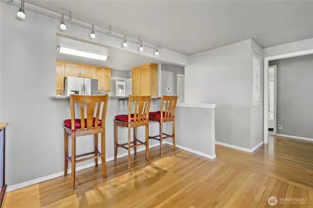 The kitchen features a convenient breakfast bar, perfectly positioned opposite the spacious dining room for seamless gatherings.