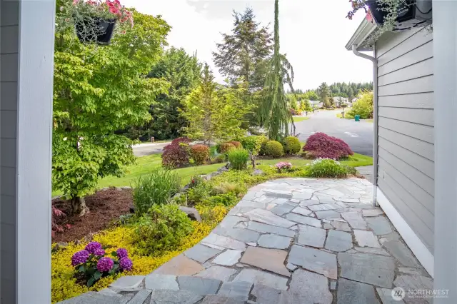 Flagstone entry way with gorgeous landscaping.