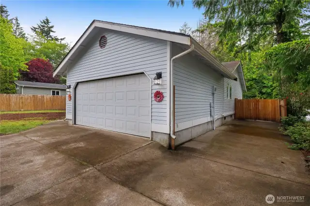 Two-car garage with a paved pad on the side-perfect for a boat, kayak, or RV. There's plenty of room to spread out. And don't miss the gate to backyard-great for privacy.