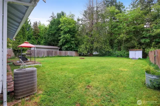 The fully fenced backyard offers privacy and space to enjoy. There's a heat pump to keep things cool on warm summer nights. A shed for all your tools, and a fire pit ready for evening hangouts.