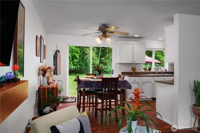 The dining area fits a nice-sized table with plenty of room to spare. Notice the cool wood mantle above fireplace.