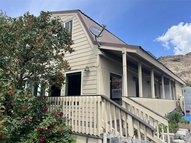 Back side of house showing covered side deck.