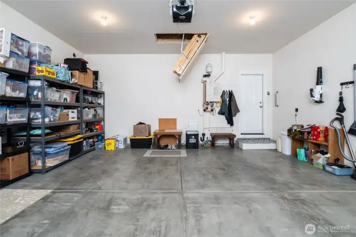 Garage with pull down ladder for extra storage.