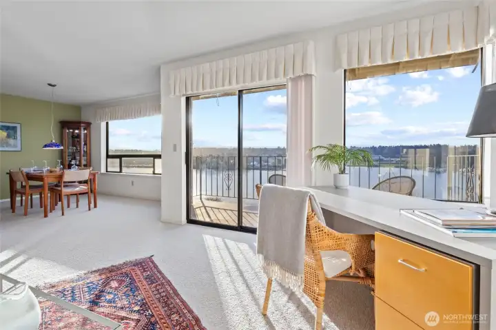 The large windows in the dining room and the sliding glass door have sunshades to control the amount of light entering the condo, and the smaller windows in the corner with the desk have blinds.
