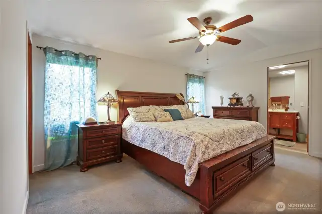 Main bedroom with king sized bed, walk in closet and private bathroom.