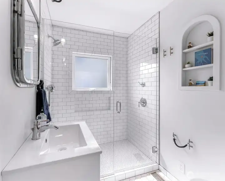 Convenient and clean walk in shower in the tastefully done bath