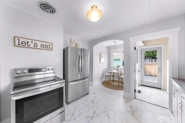 The back porch holds hosts the utility area and the breakfast nook is beyond