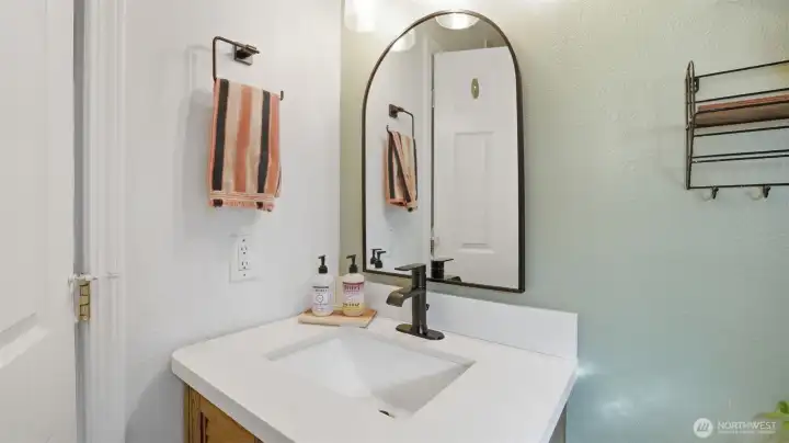 Updated bathroom vanity in full bathroom. Full tile shower surround.