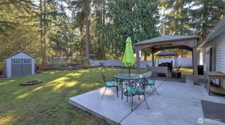 Fully fenced yard complete with covered entertainment sized patio, fire pit and shed. Only one shared fence with the back and side buffered by green space making this yard feel much more secluded than you would expect.