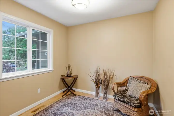 A quiet main floor office/den with warm inviting hardwoods. Perfect for working from home. or 4th bedroom