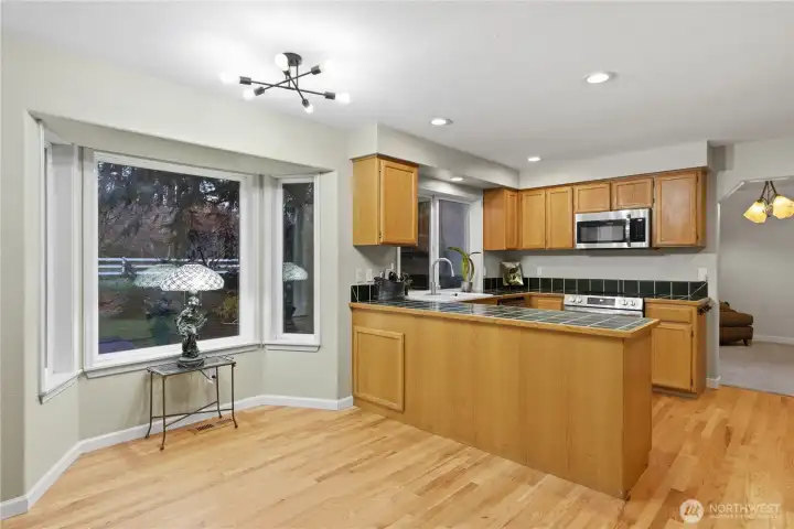 A generous eating nook filled with natural light and backyard views. Enjoy seamless flow from kitchen to family room.