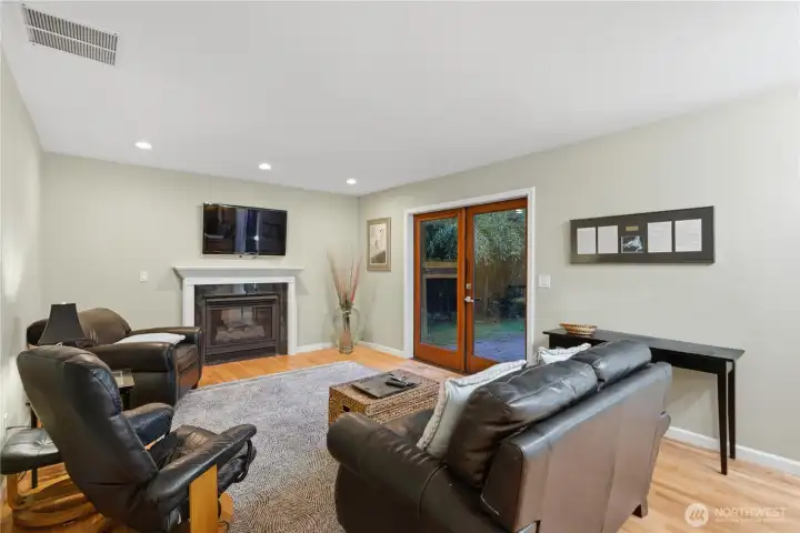 Expensive family room with gleaming hardwoods, a cozy, gas fireplace, and French doors that open to the back deck for effortless indoor outdoor living. A perfect place to gather.