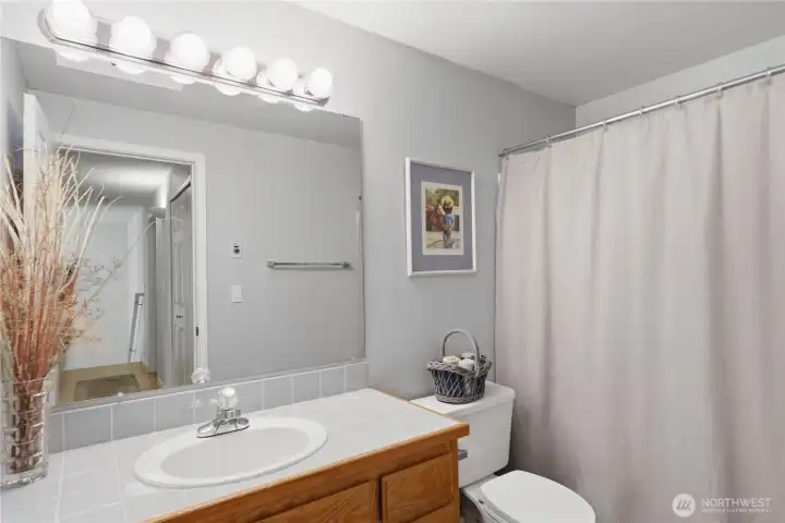 Full hallway bath with a shower tub combo. Conveniently located near the secondary bedrooms.