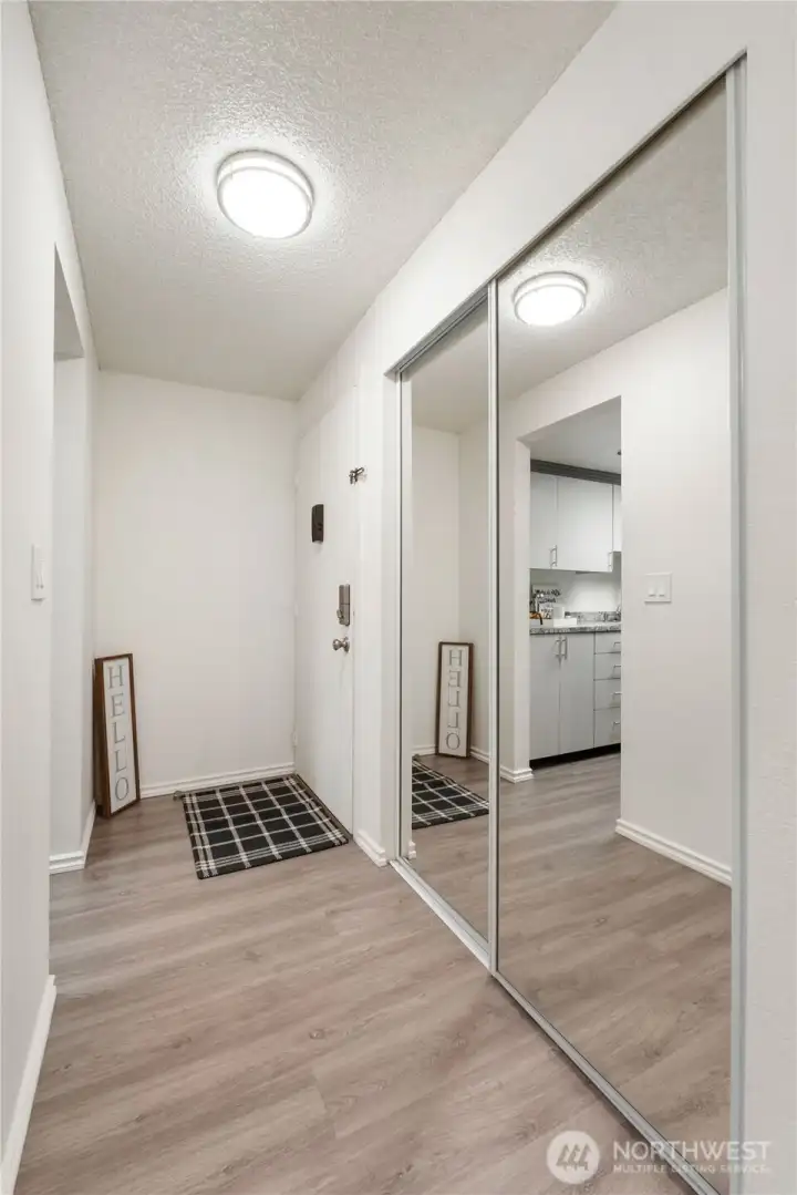 The entry showcases the nice laminate flooring and there is a large coat/storage closet