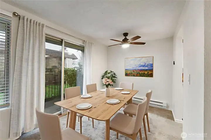 The dining space features a decorative ceiling fan light and also overlooks the courtyard. *Photo virtually staged.