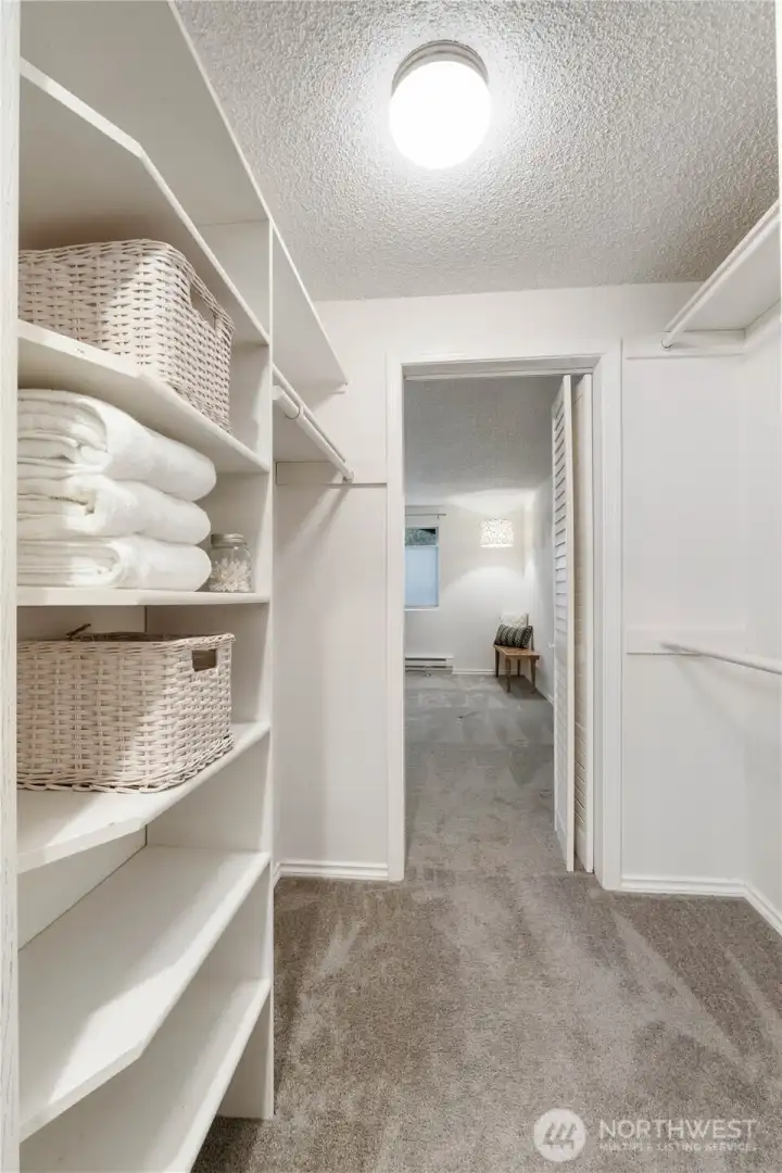 View from the large walk-in closet to the primary bedroom