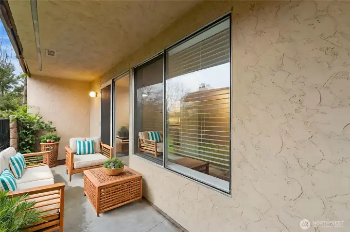 The covered patio overlooking the courtyard is a serene space for enjoying your coffee & reading a book