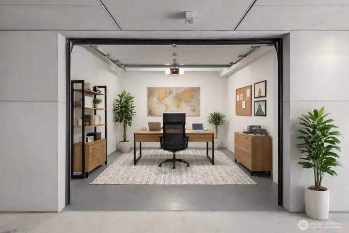 This has been virtually staged to represent an option for a home office in the private garage space.