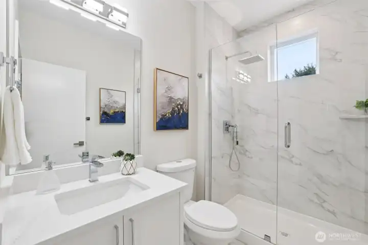 Main floor bathroom with tile surrounding all the way to the 9 ft ceiling