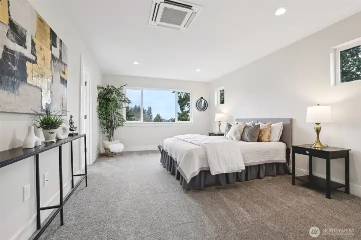 Primary bedroom with individual heating/cooling tucked in ceiling