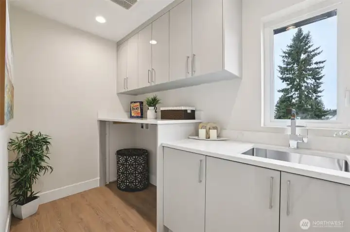 Laudry Room with built sink and built in shelf to fold. Added cabinets for extra storage