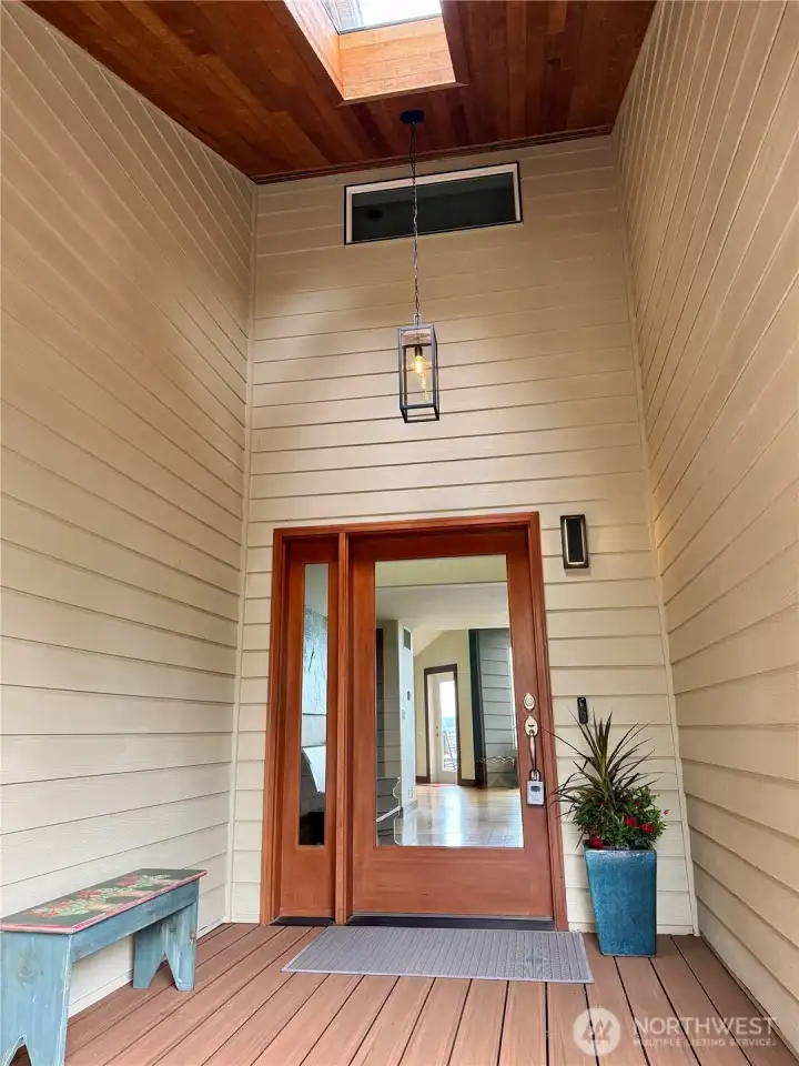Vaulted ceiling front porch with skylight, dry and sheltered.