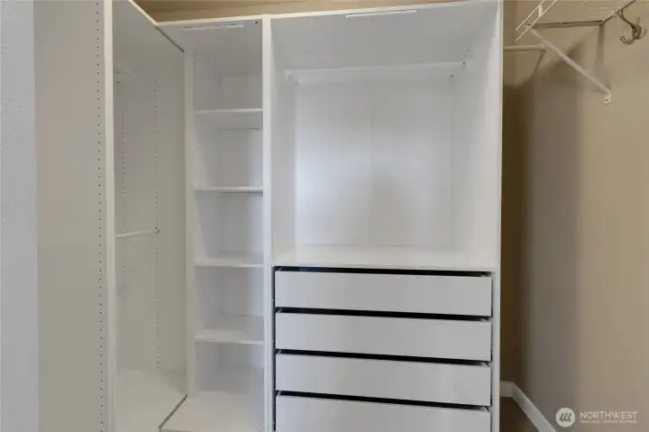 Primary custom closet with additional built-ins & lighting.
