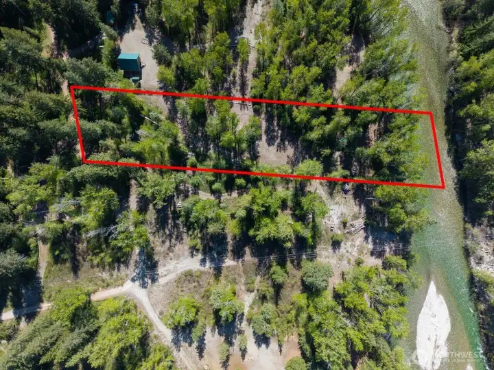 This is the dreamiest riverfront ever! Gorgeous natural setting. Level land. Building site. Small movable shed.