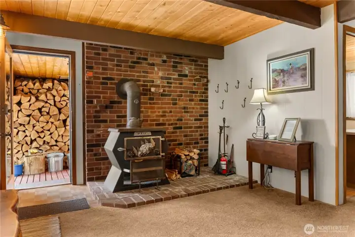 Inviting entry to main house features charming wood burning stove.