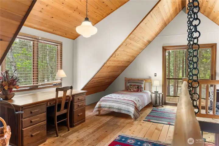 Upstairs loft area with sleeping space that opens to private deck.