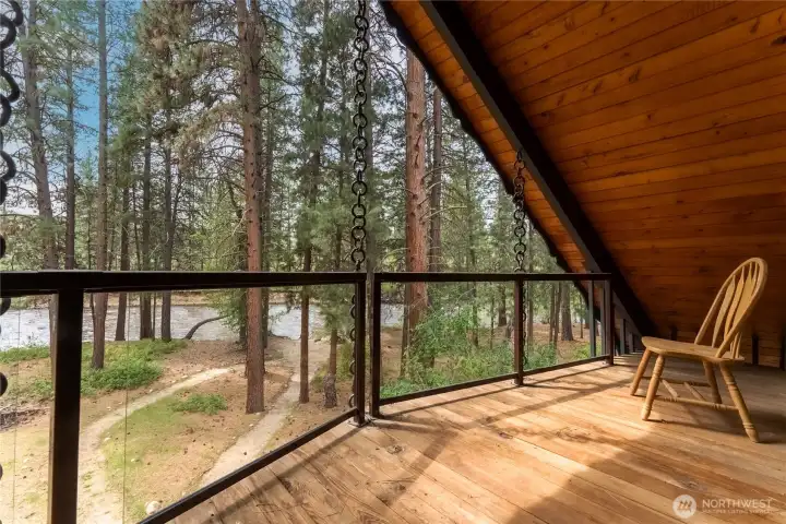 Upper-level deck overlooks the river.