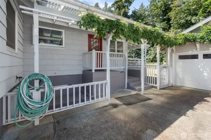 Wisteria vines welcome you through the side entrance, this is where the separate entrance to basement is located.