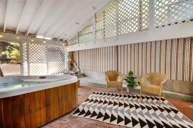 Indoor/outdoor space featuring a hot tub and brick flooring.  Opens to the zen gardens