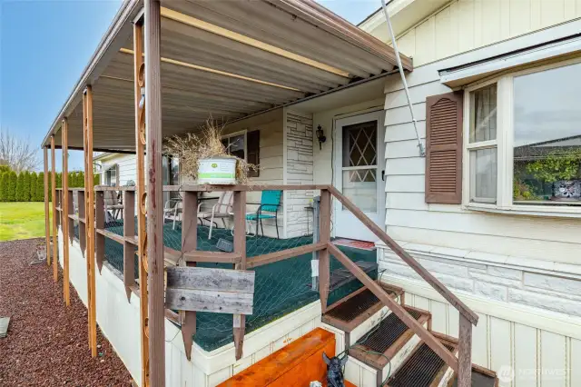 A view of the south-facing sitting porch, perfect for your tomato plants, hanging flower baskets, evening cocktails, etc.