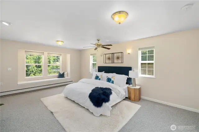 The oversized prime bedroom has storage under the window seat and the controls for the exterior security lights