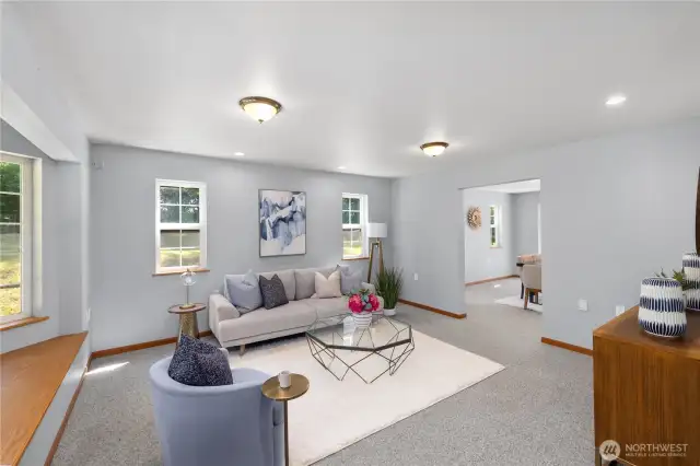 To the left as you enter is a spacious living room, perfect for conversation or quiet time