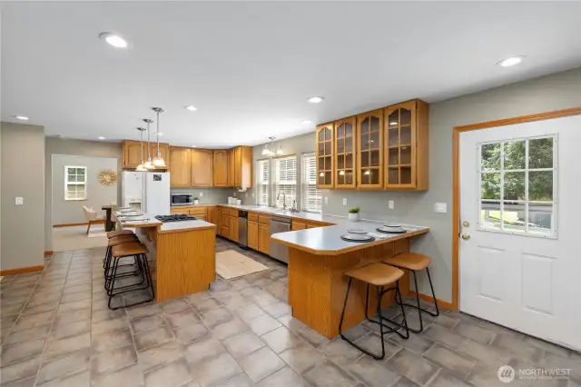 The kitchen boasts plenty of counter space, a combo breakfast bar and electric ranage - perfect for conversation while you whip up the meal.! The gas range is powered from a small propane tank on the deck.  The oven is electric.