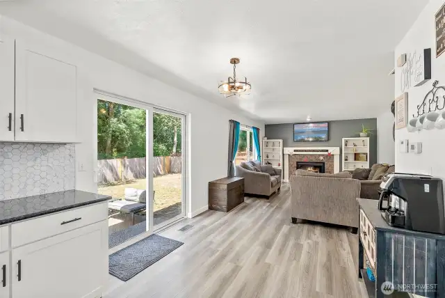 Slider of breakfast nook opens to patio in fully fenced yard.