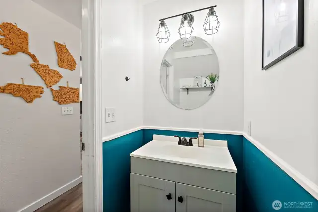 Half bath on main level with vanity storage.
