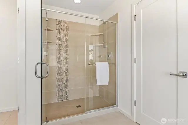 Walk-in shower in primary suite has two shower heads